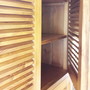 Detailansicht vom Massivholz Schrank Antra, geoeffnete Schwingtueren mit geraeumigen Faechern,